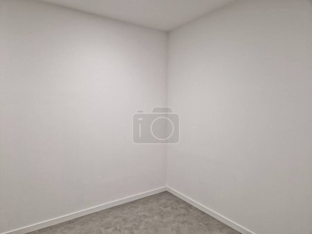 empty white room with gray carpet and shelves along entire wall. metal holders and laminate shelves for document files and storage of things, goods, clothes in dressing room. office, business  store