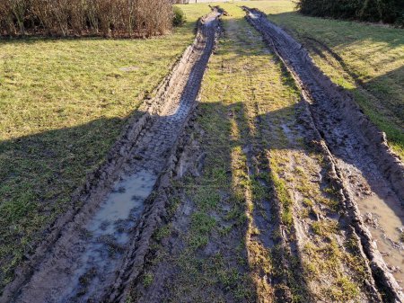 spring rains waterlogged the soil profile and lawns and meadows are mud traps for heavy vehicles. impenetrable by spring snowmelt. the rutted tracks of the car that came back