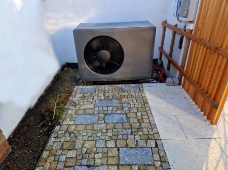 the heat pump is cleverly hidden in a niche behind the house. the gray heat exchanger makes a humming noise that disturbs the peace and annoys the neighbors. propeller fan sound