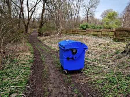 Photo for The vandals took the recycling container to the forest. lost waste containers are difficult to find again and put back in their place - Royalty Free Image