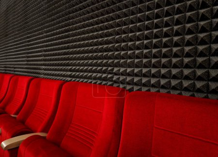 Photo for Anti noise materials for door fillings and recording studios. foam with an articulated pyramid pattern. padding shattering sound waves in the apartment, theatre, red, cinema, suede, upholstery - Royalty Free Image