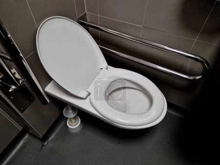 toilets for wheelchair users and disabled people have a tilting mirror that points to the ground because the height of the person sitting is lower. lever taps for easier water temperature adjustment