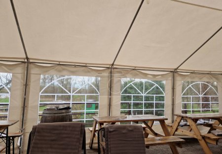 Sheets made of non-flammable materialPVC tarpaulin for trucks rear entrance equipped with zip windows made of transparent plastic Steel frame of the tent made of galvanized pipes, table, pub