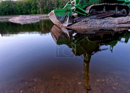 Photo for Mining of sand sedimenting in river bed. for navigation, bottom must be kept free of deposits.  driving profile for ships and steamers is maintained by a bulldozer with the ability to drive - Royalty Free Image