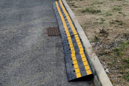 safety crossing wedge made of plastic with reflective elements. anti-skid plastic approach over the curb to the construction site