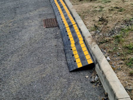 safety crossing wedge made of plastic with reflective elements. anti-skid plastic approach over the curb to the construction site