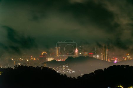 Photo for A dramatic and varied cloudy cityscape. Black is eerie and changeable. The hazy and dreamy twilight view of the city. Miaoli County, Taiwan - Royalty Free Image
