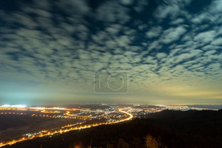 Photo for Romantic and spectacular cityscape at sunset. Moving clouds in blue sky. The hazy and dreamy twilight view of the city. Miaoli County, Taiwan - Royalty Free Image