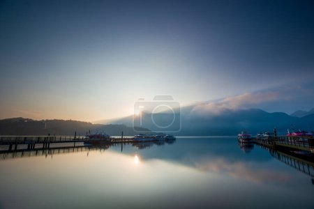Photo for Early morning lake and mountain views. The clouds and mist are changing. The mountain and lake scenery of Sun Moon Lake in the morning. Nantou, Taiwan - Royalty Free Image