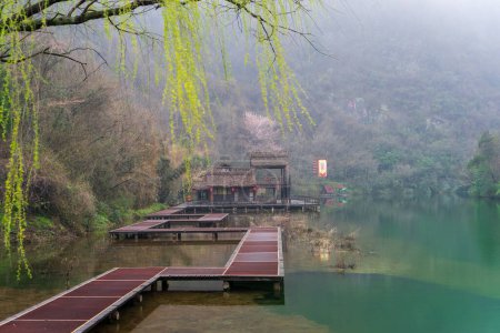 Foto de Junto al lago de la montaña Wudang en China, una bandera de la medicina tradicional china ondea al viento. - Imagen libre de derechos