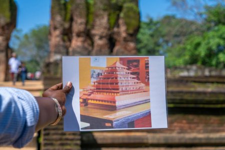 Photo for Polonnaruwa, Sri Lanka - January 25, 2024: A local guide holds a complete model of the ancient city for comparison against the ruins of the Ancient City of Polonnaruwa. - Royalty Free Image