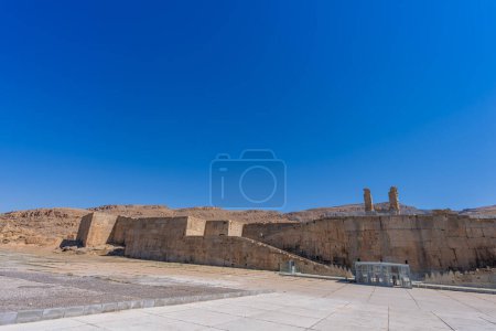 Photo for A breathtaking view of the stone ruins, standing tall against a clear blue sky. Showcasing the enduring legacy of an ancient civilization. Persepolis entrance, Iran. - Royalty Free Image
