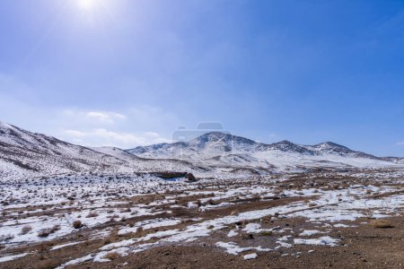 The journey from Isfahan to Tehran in March offers views of snow-capped hills at an altitude of 2,100 meters. Tehran, Iran.
