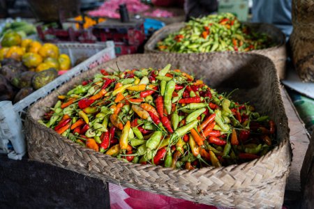 Foto de A basket full of fresh Indonesian chili peppers, also called rawit or bird's eye chili, horizontal - Imagen libre de derechos