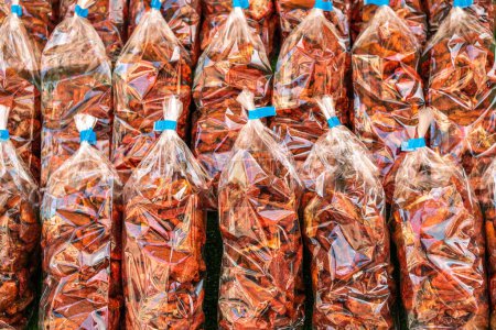 Photo for Dried tomatoes in transparent bags. Street market. Italian, Turkish dried tomatoes in identical packages on the counter. Image for advertising and sale of goods - Royalty Free Image