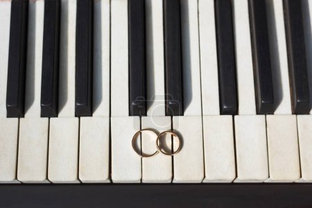 Photo for Wedding rings on the piano - Royalty Free Image
