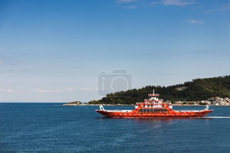 Photo for Tourist summer landscape in greece, island, port, ship, city, beach, mountains with forest, sea with turquoise and blue water, blue sky with clouds - Royalty Free Image