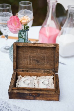 Photo for Wedding rings lie in a wooden box - Royalty Free Image