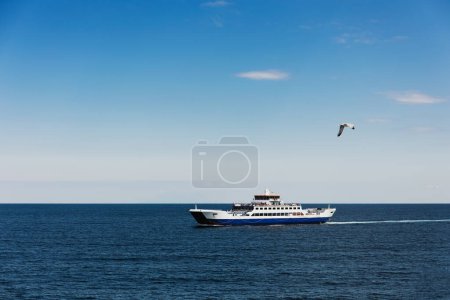 Photo for Tourist adventure colourful vacation summer landscape in greece, open sea with blue water, steam ship and seagull, blue sky with clouds - Royalty Free Image