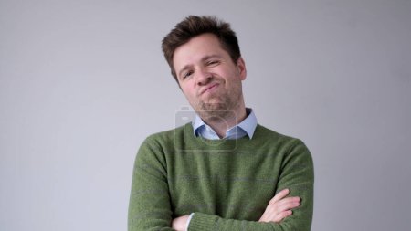 Photo for European, young man, shakes his head in disbelief and looks skeptically into the camera. Studio shot - Royalty Free Image