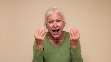 An elderly European woman asks in anger why you did it. Studio shot