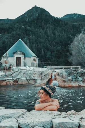 Foto de Woman relaxing inside a natural pool thermal hot volcanic water in beautiful countryside mountain scenic place. Alternative healthy lifestyle and wellbeing outdoor leisure activity female people - Imagen libre de derechos