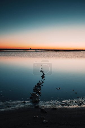 Photo for Outdoors lake at sunset. Soft sunlight, glowing pink and golden clouds, reflection in a crystal clear water. Idyllic landscape. Panoramic view. Nature, ecology, ecotourism. Peace and joy concepts - Royalty Free Image