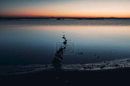 Photo for Misty seascape - calm water surface of the lake reflects lilac sky with pink and blue clouds after sunset. White nights season in the Republic of Karelia, Russia. Blur filter, space for copy. - Royalty Free Image