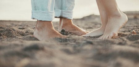 Photo for Couple feet kissing and loving concept. Outdoor leisure activity. Relationship, boy and girl in summer at the beach. People enjoying sand and nature. Barefoot man and woman unrecognizable. Romance - Royalty Free Image