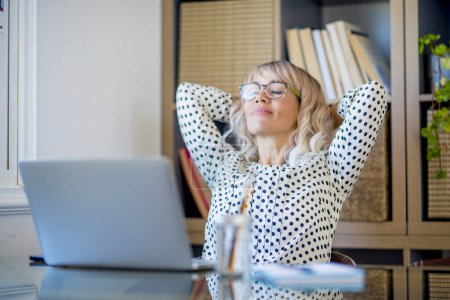 Photo for Healthy office lifestyle people concept.  satisfied businesswoman stretching arms under her head and smile after finish the day of work at home office. Concept of success and relax - Royalty Free Image