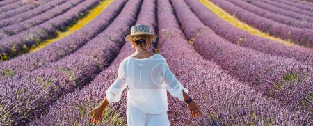Photo for Summer holiday travel destination Europe lavender field tourism.  woman back view white elegant dress walking in purple flowers enjoying outdoor nature leisure activity alone. Traveler lifestyle - Royalty Free Image
