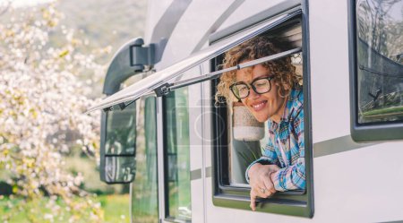 Photo for One happy  female people enjoying travel destination smiling outside the window of modern camper van motor home alternative tiny house. Transport and tourism concept lifestyle Nature parking - Royalty Free Image