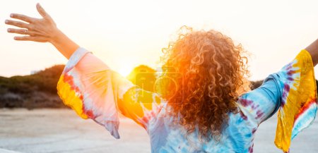 Photo for Travel and scenic destination people concept.  woman in rear view opening arms and hug nature and orange sunset. Outdoor leisure activity people on vacation. Happiness and freedom healthy lifestyle - Royalty Free Image