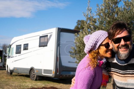 Photo for Happy couple of tourist take selfie picture in the country side with modern camper van motorhone rv vehicle parked in background. Happy man and woman travel lifestyle. Tourism tourist outdoor - Royalty Free Image