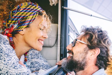 Photo for Happy adult tourist and traveler smile and have fun together inside and outside the camper car. Cheerful happy people enjoying travel and vacation. Mature couple in love and friendship portrait - Royalty Free Image