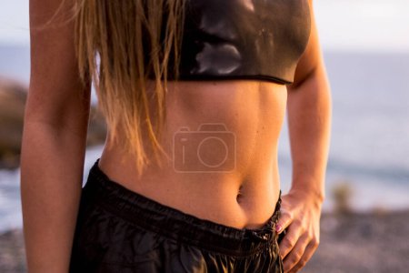 Photo for Close up of beautiful female belly with abdominal muscles - concept of healthy lifestyle and health body care people - caucasian woman after exercises fitness sport outdoor - Royalty Free Image