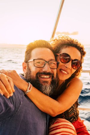 Photo for Cheerful and happy adult couple smile and enjoy the sail boat yacht trip in summer day holiday vacation travel adventure lifestyle - love and romantic life - Royalty Free Image