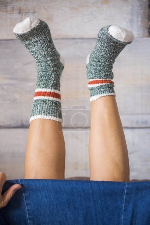 Photo for Pair of woman legs with warm socks at home in reverse position . concept of happiness and quarantine disease for female people alone - Royalty Free Image