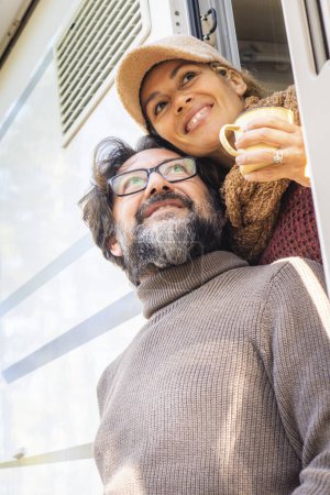 Photo for Couple enjoys the weekend aboard their camper. Happy man together with his wife spending pleasant moments. Concept of freedom and free time - Royalty Free Image