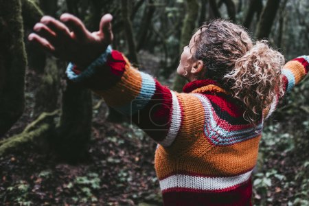 Freedom people enjoying feeling with nature forest. Woman outstretching arms in the green woods. Leisure and trees protection. Earth's day and life scenic place. Tourist in travel amazing destination