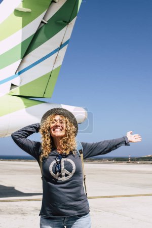 Photo for Tourism and tourist travel happy people concept with cheerful and joyful adult beautiful woman ready to leave with the aircraft and fly to destination for holiday vacation - Royalty Free Image
