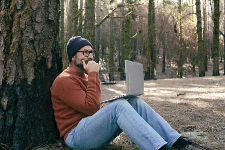 Photo for Man using technology connection in nature park forest woods. Remote worker small travel business lifestyle people. Working in the nature alternative office. Small business. Travelers job life - Royalty Free Image