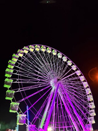 Photo for Amusement park at night - ferris wheel in motion. Concept of holiday people and have fun. Nightlife vacation. - Royalty Free Image