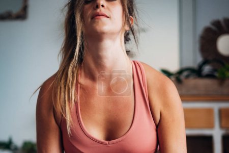 Front view of sporty woman at home doing push up exercise alone for her wellness and happiness. Healthy lifestyle female people. Young having hard workout indoor at house. People in training activity