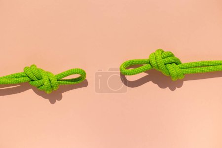 Photo for Climbing rope with a knot lies on a colored background.  the concept of reliability and safety. - Royalty Free Image