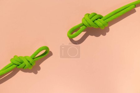 Photo for Climbing rope with a knot lies on a colored background.  the concept of reliability and safety. - Royalty Free Image
