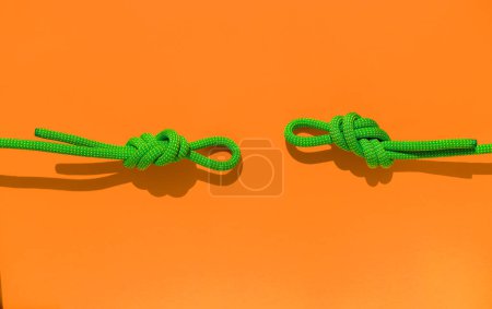Photo for Two ropes with secure knots. climbing rope with a knot lies on a colored background. concept of reliability and safety. rope with a knot. - Royalty Free Image