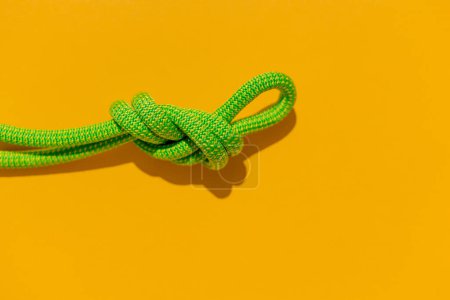 Photo for Rope with a secure knot. concept of reliability and safety. climbing rope with a knot lies on a colored background. rope with a knot. - Royalty Free Image