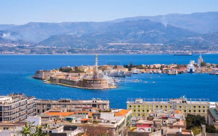 The Strait of Messina between Sicily and Italy. View from Messina town with golden statue of Madonna della Lettera and entrance to harbour. Calabria coastline in background.