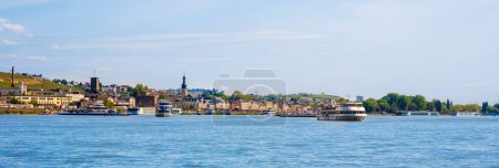 Panorama of Rudesheim am Rhein town on Rhine river near Bingen, Germany. Waterfront with cruise ships. Rhine valley is popular tourist destination for river cruise and short vacation.